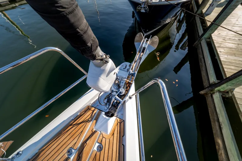 Serenity Yacht Photos Pics Bow of 2016 Jeanneau 64 yacht with anchor and teak deck at marina.