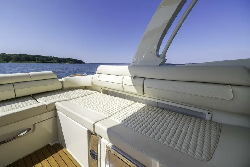 Get Back Yacht Photos Pics 2022 Chris-Craft Launch 31 GT interior with luxurious seating, overlooking serene water and clear sky.