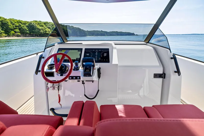 Outrageous Yacht Photos Pics 2024 Vanquish Yachts VQ 40 helm with red seats and modern controls.