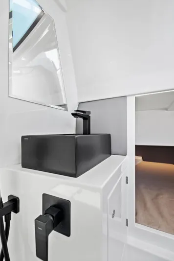 Outrageous Yacht Photos Pics Modern interior of 2024 Vanquish Yachts VQ 40 with sleek black fixtures.