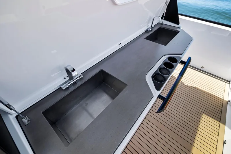 Outrageous Yacht Photos Pics Vanquish Yachts VQ 40 2024 yacht kitchen area with sink and cup holders.