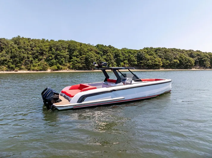 Outrageous Yacht Photos Pics 2024 Vanquish Yachts VQ 40 on a serene lake with lush green trees in the background.