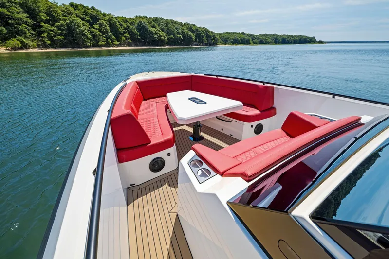 Outrageous Yacht Photos Pics 2024 Vanquish Yachts VQ 40 with red seating and table on a serene lake.