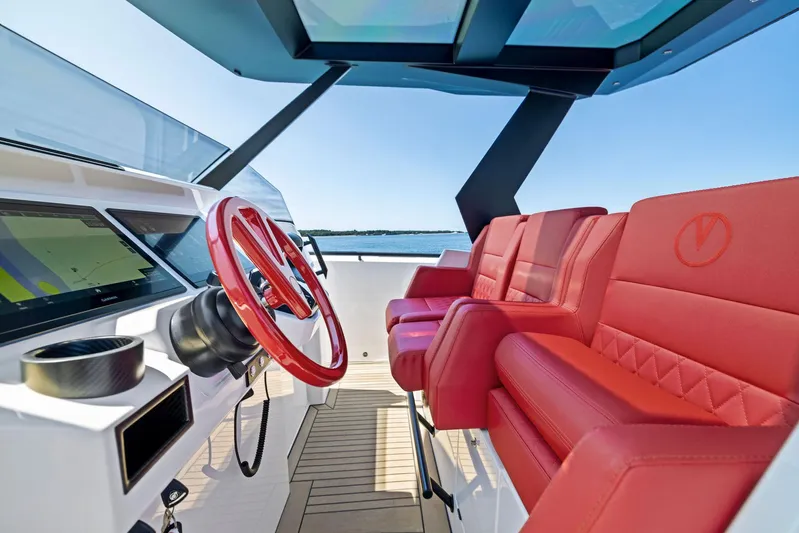 Outrageous Yacht Photos Pics 2024 Vanquish Yachts VQ 40 interior with red seats and modern helm.