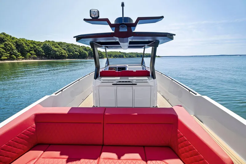 Outrageous Yacht Photos Pics 2024 Vanquish Yachts VQ 40 with red seating, cruising on a serene lake.