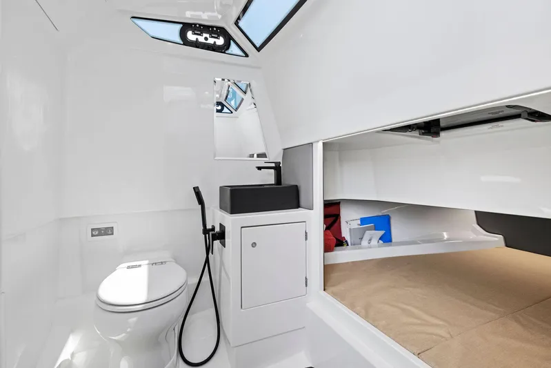Outrageous Yacht Photos Pics Modern bathroom interior of 2024 Vanquish Yachts VQ 40 with toilet and sink.