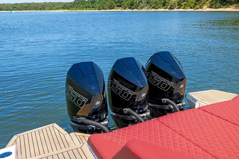 Outrageous Yacht Photos Pics 2024 Vanquish Yachts VQ 40 with triple outboard engines on a serene lake.