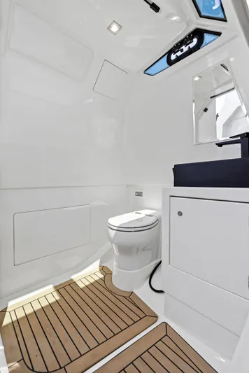 Outrageous Yacht Photos Pics Modern bathroom interior of 2024 Vanquish Yachts VQ 40 with wooden flooring.
