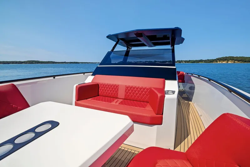 Outrageous Yacht Photos Pics 2024 Vanquish Yachts VQ 40 with red seating and white table on open water.