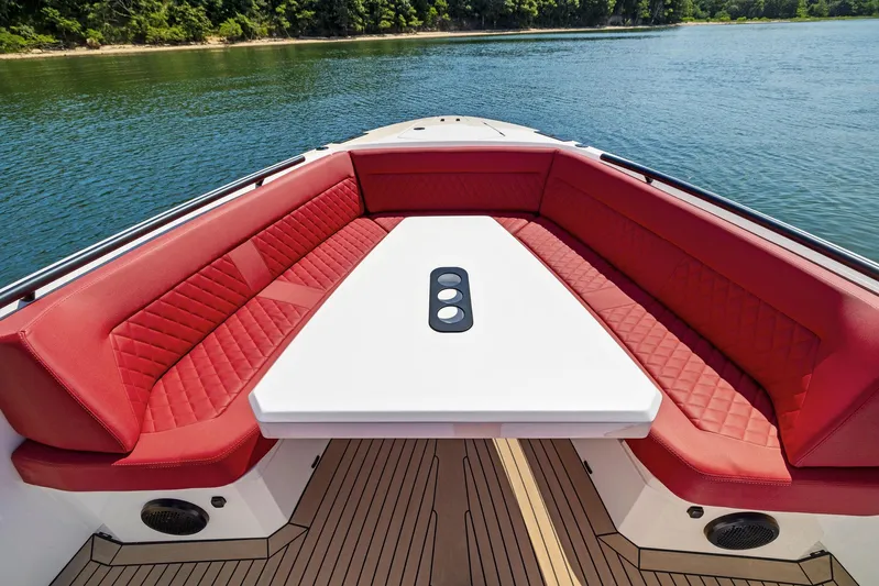 Outrageous Yacht Photos Pics 2024 Vanquish Yachts VQ 40 with red seating and white table on water.