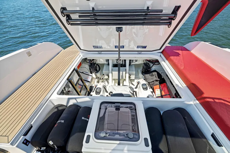 Outrageous Yacht Photos Pics Open engine compartment of 2024 Vanquish Yachts VQ 40, showcasing storage and mechanical components.