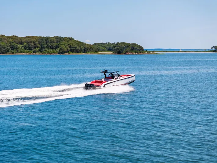 Outrageous Yacht Photos Pics 2024 Vanquish Yachts VQ 40 cruising on a serene blue lake.