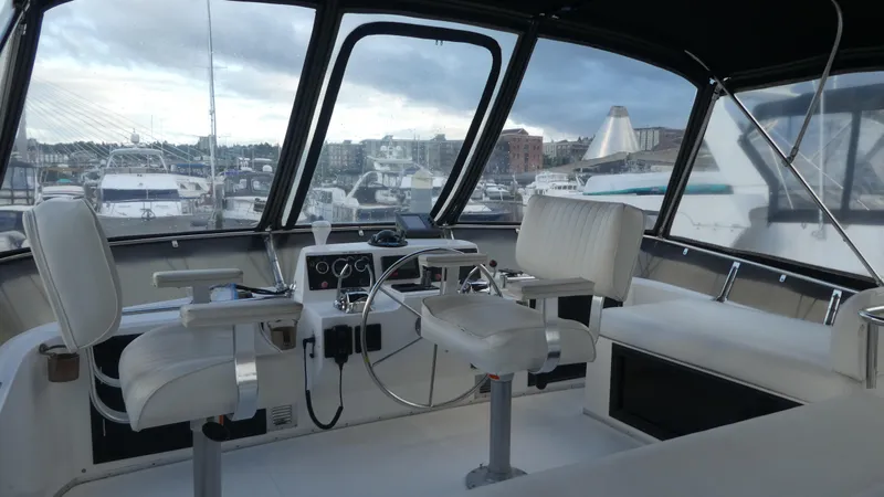 Morning Star Yacht Photos Pics 1993 Ocean Alexander 440 Sundeck CPMY cockpit with marina view, featuring helm and seating.