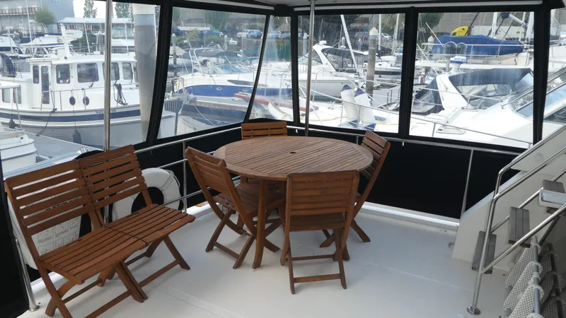 Morning Star Yacht Photos Pics 1993 Ocean Alexander 440 Sundeck CPMY with wooden deck furniture, marina view.