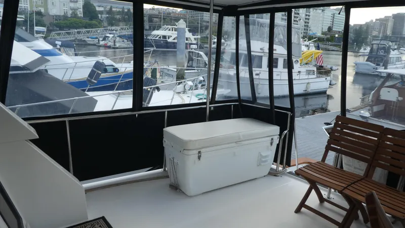 Morning Star Yacht Photos Pics 1993 Ocean Alexander 440 Sundeck CPMY yacht interior with marina view, featuring seating and storage.