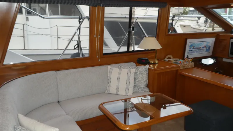 Morning Star Yacht Photos Pics Interior of 1993 Ocean Alexander 440 Sundeck CPMY with cozy seating and wooden accents.