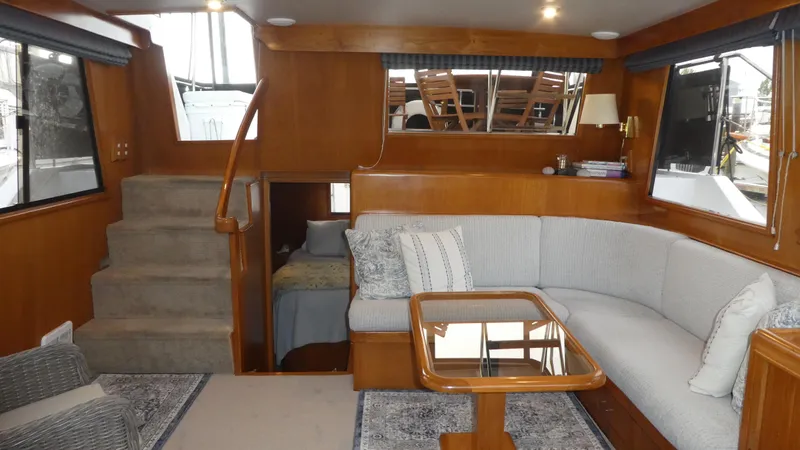 Morning Star Yacht Photos Pics Interior of 1993 Ocean Alexander 440 Sundeck CPMY with cozy seating and wooden accents.