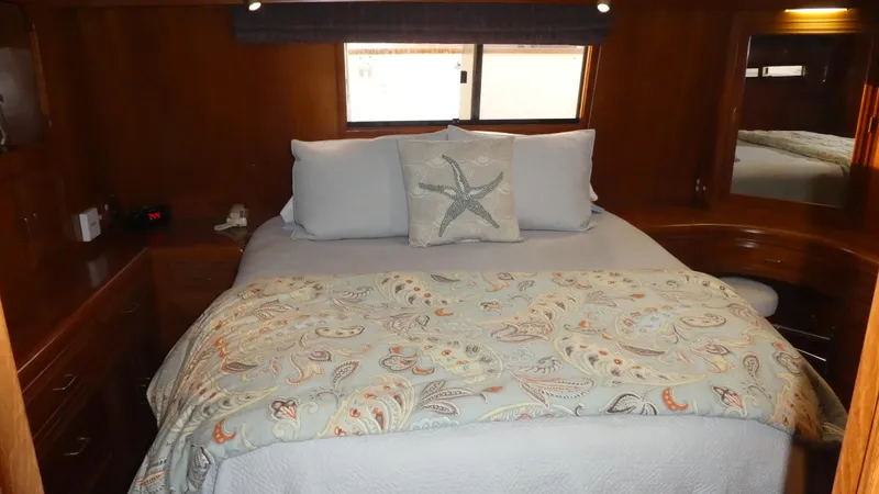Morning Star Yacht Photos Pics Cozy bedroom in 1993 Ocean Alexander 440 Sundeck CPMY with nautical-themed bedding.