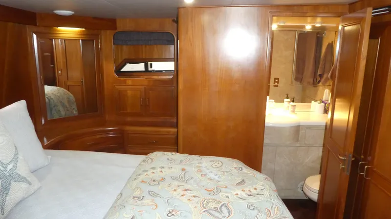 Morning Star Yacht Photos Pics Luxurious 1993 Ocean Alexander 440 Sundeck CPMY cabin with wood paneling and ensuite bathroom.