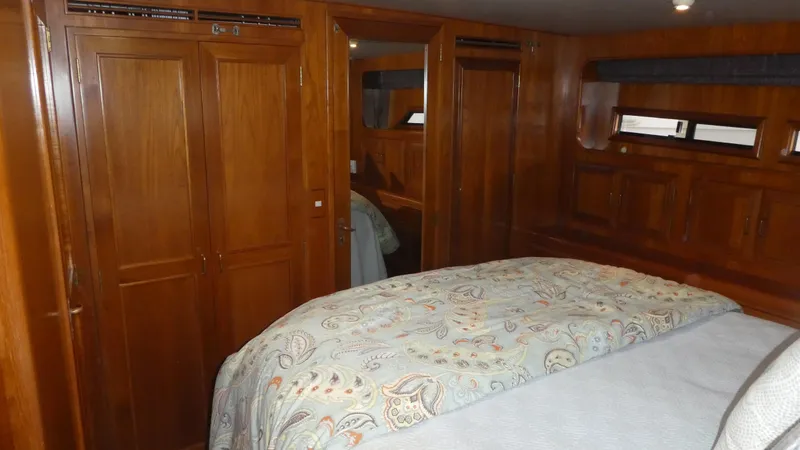 Morning Star Yacht Photos Pics Luxurious 1993 Ocean Alexander 440 Sundeck CPMY cabin with wood paneling and cozy bedding.
