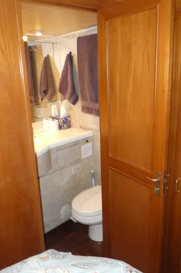 Morning Star Yacht Photos Pics Bathroom interior of 1993 Ocean Alexander 440 Sundeck CPMY yacht, featuring wooden door and modern amenities.