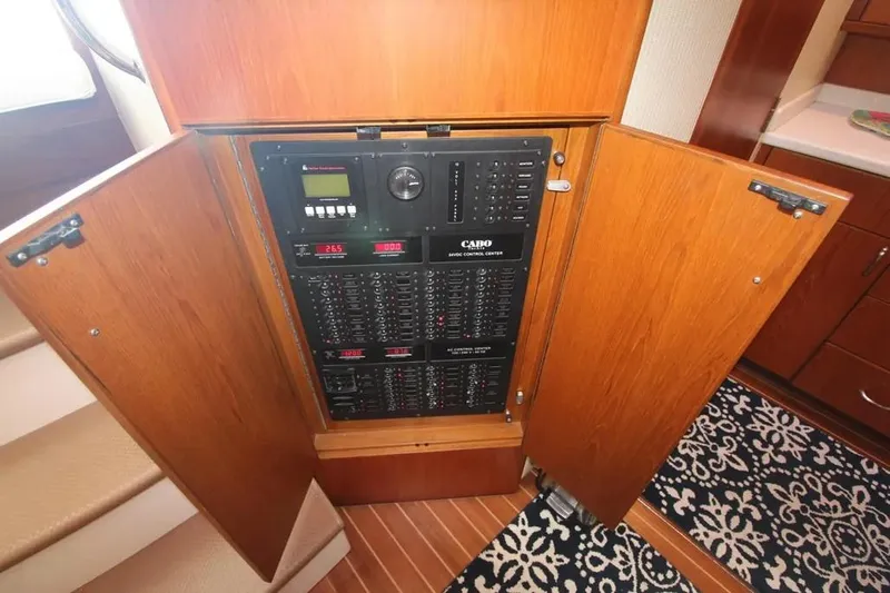  Yacht Photos Pics Electrical panel inside 2013 Cabo 40 Hardtop Express yacht with wooden cabinetry.