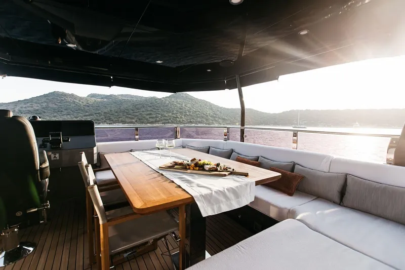  Yacht Photos Pics Luxurious 2022 Bering 70 yacht deck with elegant dining area and scenic ocean view.