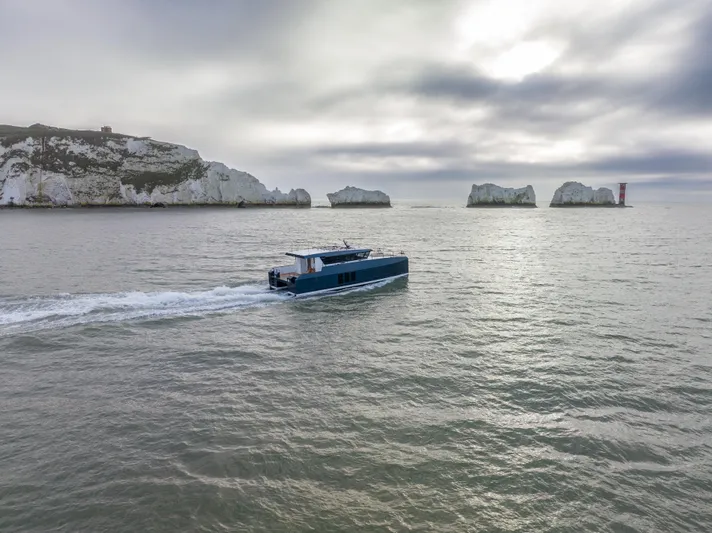  Yacht Photos Pics Modern Archipelago 47 boat cruising near rocky coastline, 2025 model.