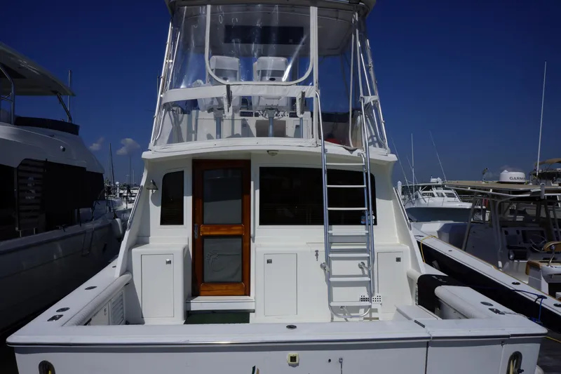 Musn't Touch It Yacht Photos Pics 1996 Egg Harbor 38 Sport Fish boat docked at marina, rear view.