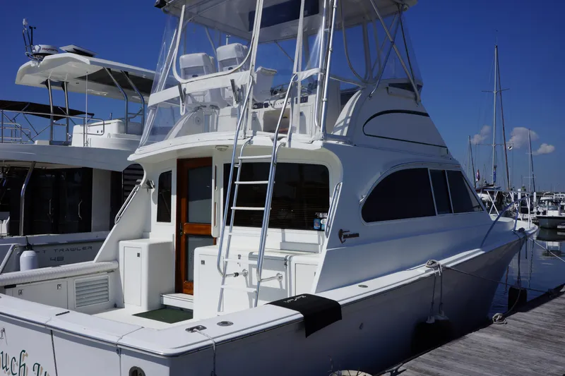 Musn't Touch It Yacht Photos Pics 1996 Egg Harbor 38 Sport Fish yacht docked at marina, featuring sleek design and flybridge.