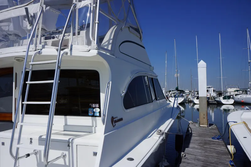 Musn't Touch It Yacht Photos Pics 1996 Egg Harbor 38 Sport Fish yacht docked at a marina under clear blue skies.