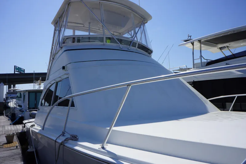 Musn't Touch It Yacht Photos Pics 1996 Egg Harbor 38 Sport Fish yacht docked, featuring sleek design and spacious flybridge.