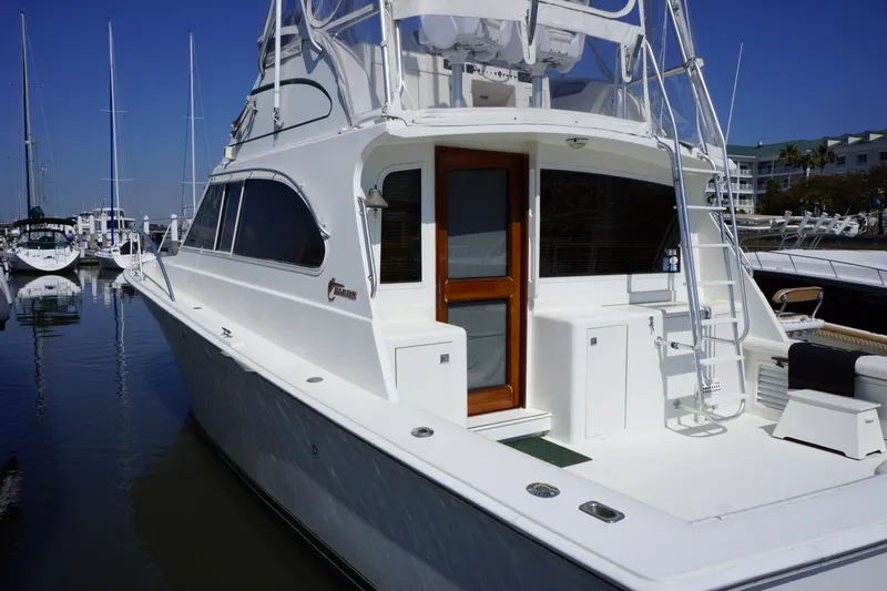 Musn't Touch It Yacht Photos Pics 1996 Egg Harbor 38 Sport Fish yacht docked at marina, showcasing sleek design and spacious deck.