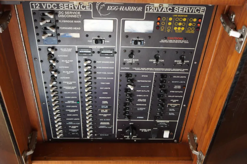 Musn't Touch It Yacht Photos Pics Electrical panel of a 1996 Egg Harbor 38 Sport Fish boat, showcasing 12V DC and AC services.