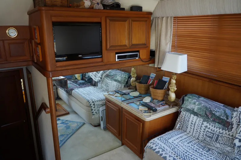 Musn't Touch It Yacht Photos Pics Interior of 1996 Egg Harbor 38 Sport Fish yacht with cozy seating and wooden cabinetry.