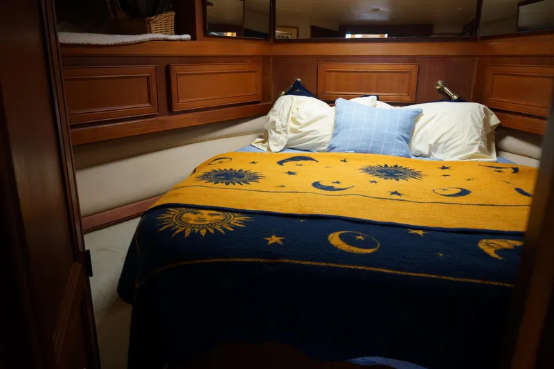 Musn't Touch It Yacht Photos Pics Cozy cabin bedroom in 1996 Egg Harbor 38 Sport Fish boat with celestial-themed bedding.