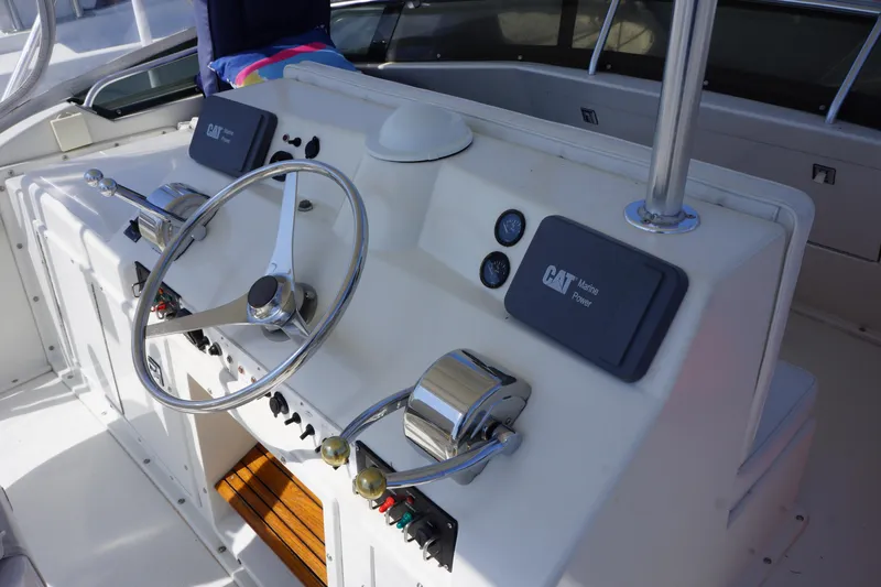 Musn't Touch It Yacht Photos Pics 1996 Egg Harbor 38 Sport Fish helm with steering wheel and controls.