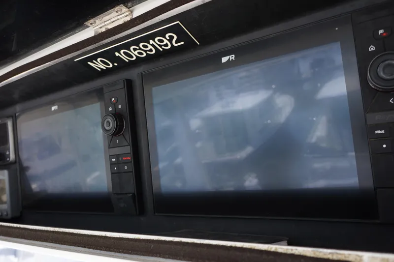 Musn't Touch It Yacht Photos Pics Control panel of a 1996 Egg Harbor 38 Sport Fish boat with navigation screens.