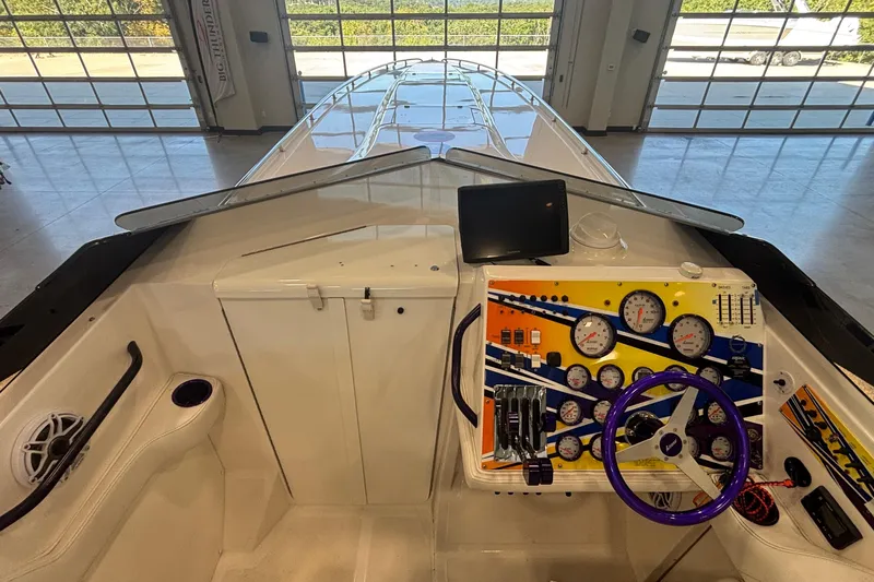  Yacht Photos Pics 2006 Fountain 42 Executioner boat cockpit with colorful dashboard and steering wheel.