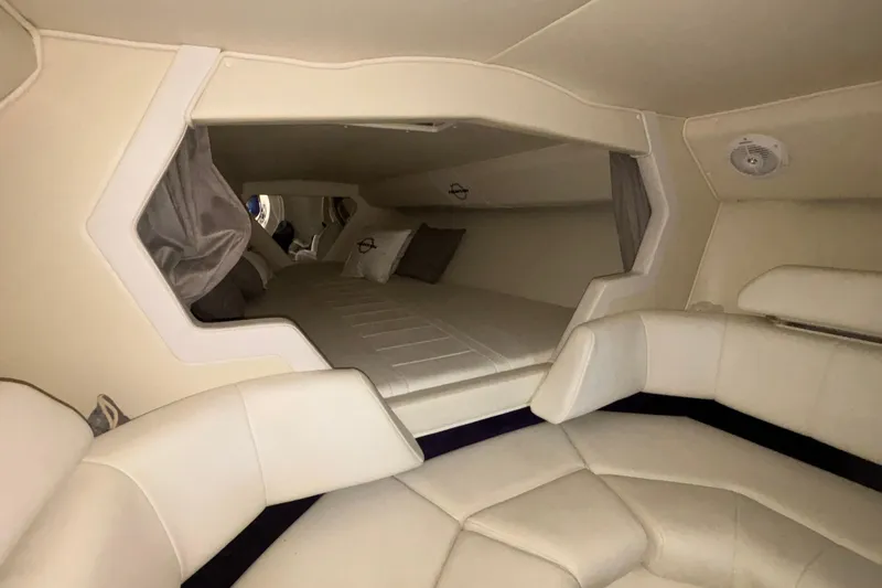  Yacht Photos Pics Interior cabin of 2006 Fountain 42 Executioner boat with beige seating and bedding.