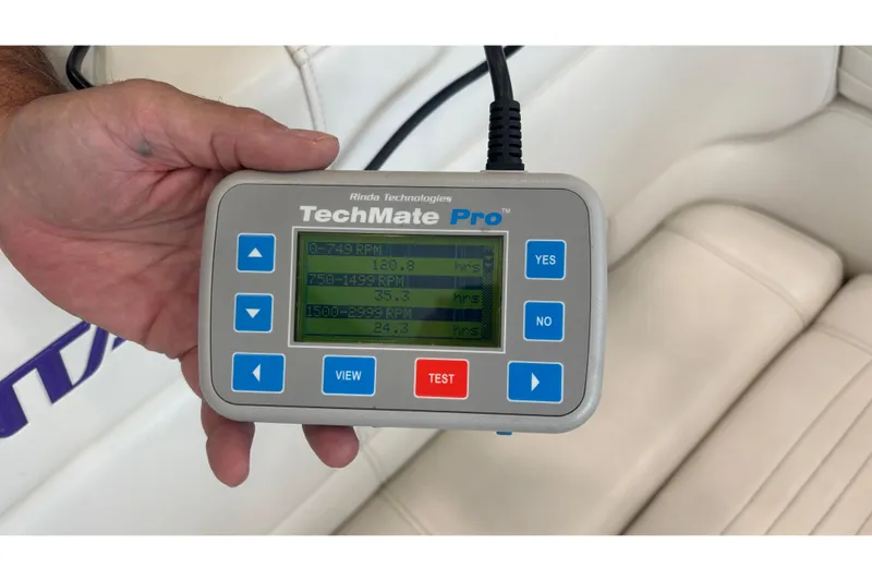 Yacht Photos Pics Hand holding TechMate Pro diagnostic tool inside 2006 Fountain 42 Executioner boat.