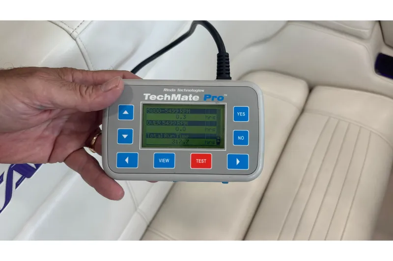  Yacht Photos Pics Hand holding TechMate Pro diagnostic tool inside 2006 Fountain 42 Executioner boat.