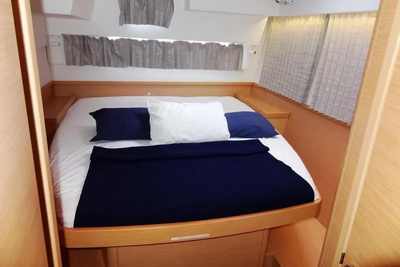 Pau Hana Yacht Photos Pics Cabin interior of 2020 Lagoon 42 catamaran with cozy bed and curtains.