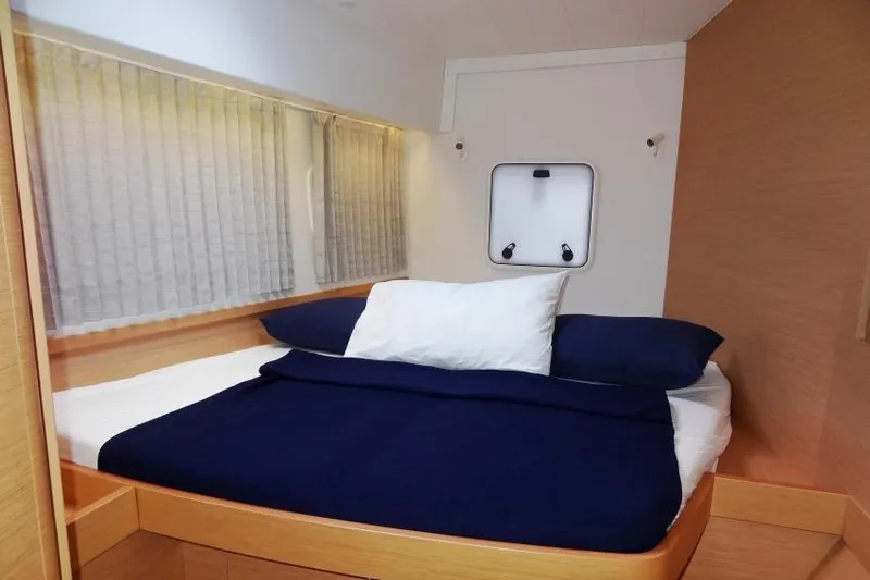Pau Hana Yacht Photos Pics Cozy bedroom in 2020 Lagoon 42 yacht with navy bedding and natural light.
