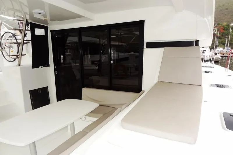 Pau Hana Yacht Photos Pics 2020 Lagoon 42 yacht interior with seating and table, featuring modern design elements.