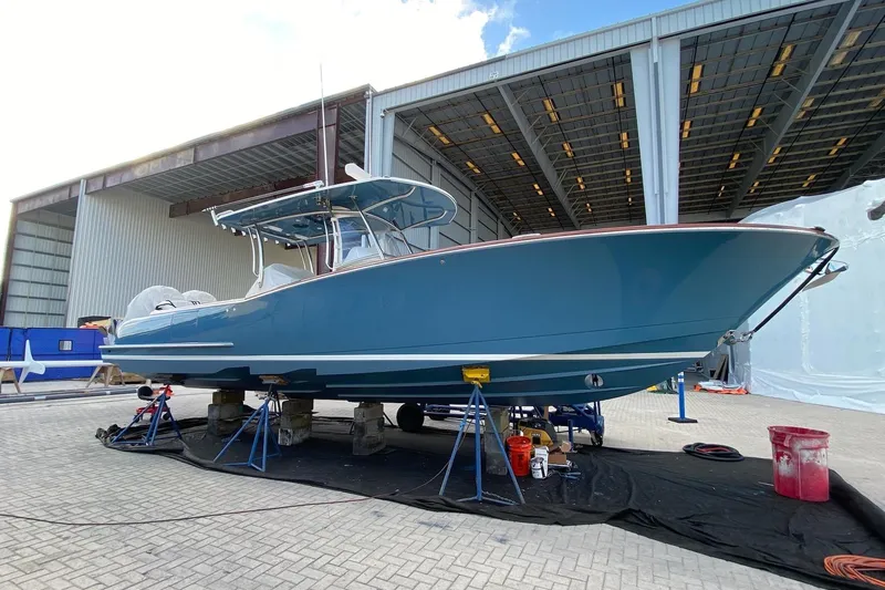  Yacht Photos Pics 2019 Mag Bay 33 CC boat in a shipyard, elevated on stands for maintenance.
