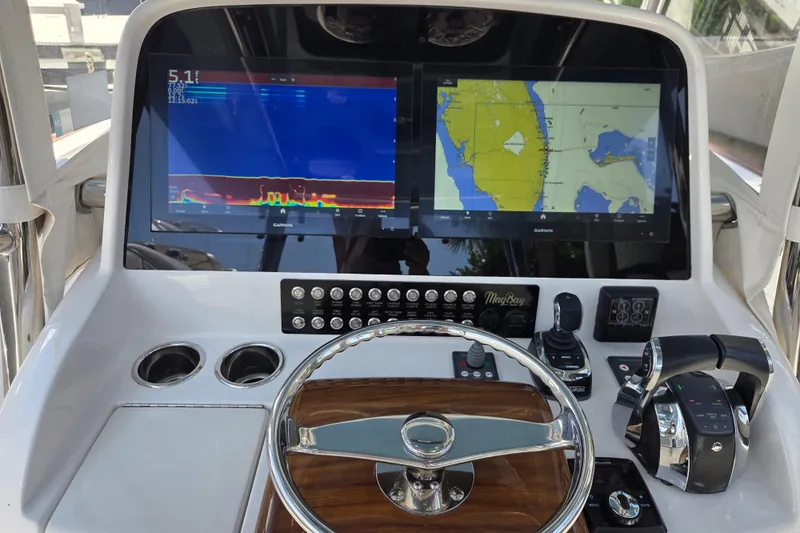  Yacht Photos Pics 2019 Mag Bay 33 CC boat dashboard with Garmin navigation displays and controls.