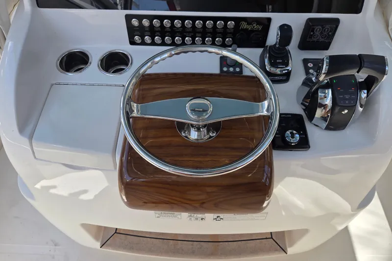  Yacht Photos Pics 2019 Mag Bay 33 CC helm with steering wheel, controls, and cup holders.
