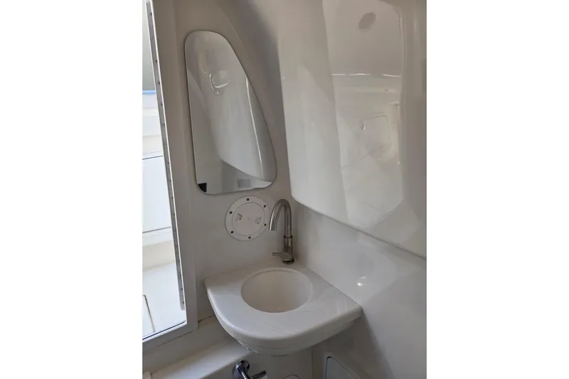  Yacht Photos Pics 2019 Mag Bay 33 CC boat interior with compact sink and mirror.