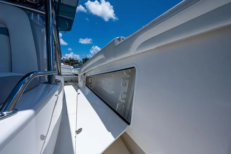  Yacht Photos Pics 2019 Mag Bay 33 CC boat interior with open storage compartment under clear blue sky.